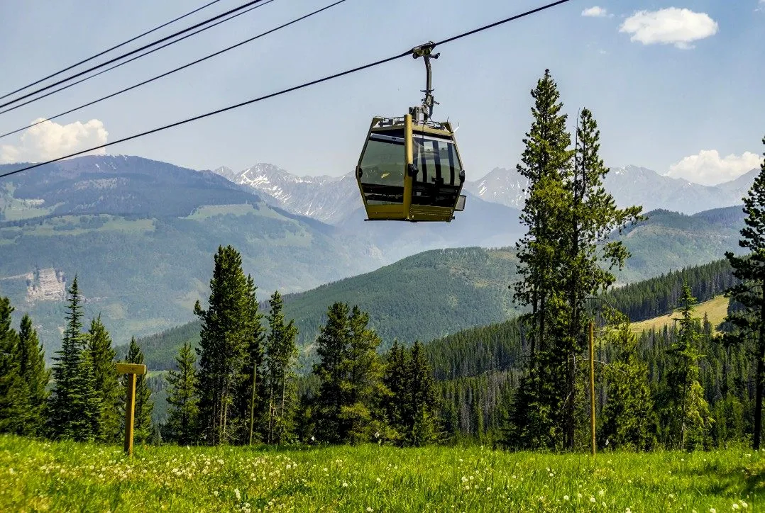 Vail gondola rides ascending mountain with scenic Colorado views
